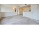 Spacious living room with carpeted floor and kitchen views at 2051 Hussium Hills St # 207, Las Vegas, NV 89108