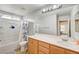 Bathroom with a tub, toilet, and wood vanity at 221 Raptors View Ave, North Las Vegas, NV 89031