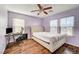 Bedroom with queen bed, ceiling fan, and wood floors at 221 Raptors View Ave, North Las Vegas, NV 89031