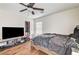 Bedroom features a ceiling fan and wood-look floors at 221 Raptors View Ave, Las Vegas, NV 89031