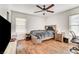 This bedroom has a ceiling fan and wood-look floors at 221 Raptors View Ave, Las Vegas, NV 89031