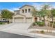 Two-story house with beige exterior, three-car garage, and landscaping at 221 Raptors View Ave, North Las Vegas, NV 89031