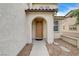 Light brown front door entryway with stone pathway at 221 Raptors View Ave, North Las Vegas, NV 89031