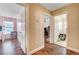 Home hallway with wood flooring and access to bedrooms at 221 Raptors View Ave, North Las Vegas, NV 89031