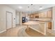 Kitchen boasts an island, stainless steel appliances, and wood cabinets at 221 Raptors View Ave, North Las Vegas, NV 89031