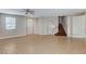 Expansive living room featuring tile flooring, neutral walls, a staircase and ample space for various seating arrangements at 221 Raptors View Ave, Las Vegas, NV 89031