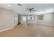 Open-concept living room with tile flooring, neutral walls, staircase, and views into adjacent rooms, perfect for entertaining at 221 Raptors View Ave, Las Vegas, NV 89031