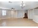 Open concept living room features tile flooring, ceiling fan, and staircase at 221 Raptors View Ave, Las Vegas, NV 89031