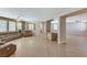 Wide view of the living room showing the tile flooring and open floorplan at 221 Raptors View Ave, Las Vegas, NV 89031