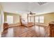 Main bedroom with hardwood floors, a ceiling fan, and large windows at 221 Raptors View Ave, North Las Vegas, NV 89031