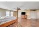 Main bedroom with hardwood floors, ceiling fan, and large windows at 221 Raptors View Ave, North Las Vegas, NV 89031