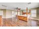 Main bedroom with hardwood floors, ceiling fan, and ensuite bathroom access at 221 Raptors View Ave, North Las Vegas, NV 89031