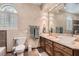 Bathroom features dual sinks, marble countertops, and decorative textured walls for a luxurious spa-like feel at 24 Wild Dunes Ct, Las Vegas, NV 89113