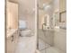 Bright bathroom featuring double sinks, sleek vanity, soaking tub, and glass-enclosed shower at 24 Wild Dunes Ct, Las Vegas, NV 89113