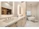 Modern bathroom featuring double sinks, sleek vanity, soaking tub, and elegant fixtures at 24 Wild Dunes Ct, Las Vegas, NV 89113