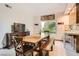 Bright dining area with a large window, wooden table, and tile floors at 24 Wild Dunes Ct, Las Vegas, NV 89113