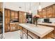 Spacious kitchen with custom wood cabinets, large central island, and stainless steel appliances at 24 Wild Dunes Ct, Las Vegas, NV 89113