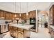 This kitchen features custom wood cabinets, stainless steel appliances, large central island and tile floors at 24 Wild Dunes Ct, Las Vegas, NV 89113