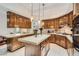 Gourmet kitchen featuring custom wood cabinets, central island with white counters, and recessed lighting at 24 Wild Dunes Ct, Las Vegas, NV 89113