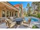 Inviting backyard pool is surrounded by ample seating and lush landscaping, perfect for outdoor living at 24 Wild Dunes Ct, Las Vegas, NV 89113