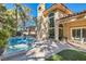 Stunning backyard view featuring a pool with a spa, outdoor seating, and beautiful landscaping at 24 Wild Dunes Ct, Las Vegas, NV 89113