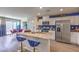 Contemporary kitchen with stainless steel appliances and a blue accent wall at 2558 Petunia Garden Ave # 217, North Las Vegas, NV 89081