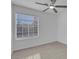 Bright bedroom with large window, ceiling fan, and light grey vinyl flooring at 2619 Grey Stone Rd, Henderson, NV 89074