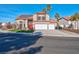 Two-story house with three-car garage, solar panels, and landscaped yard at 2619 Grey Stone Rd, Henderson, NV 89074