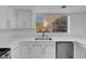 Kitchen with white cabinets, quartz countertops and stainless steel dishwasher at 2619 Grey Stone Rd, Henderson, NV 89074