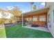 Backyard patio with wooden pergola, artificial turf and privacy fence at 2619 Grey Stone Rd, Henderson, NV 89074