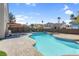 Inviting kidney shaped pool with waterfall feature and spacious patio area at 2619 Grey Stone Rd, Henderson, NV 89074