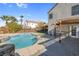 Relaxing kidney shaped pool with pergola, brick patio and waterfall feature at 2619 Grey Stone Rd, Henderson, NV 89074