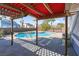 Inviting kidney shaped pool with brick patio and pergola cover at 2619 Grey Stone Rd, Henderson, NV 89074