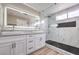 Modern bathroom with double vanity, marble shower, and frameless glass at 275 Adorno Dr, Henderson, NV 89074