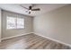 Bright bedroom with wood-look floors and a ceiling fan at 275 Adorno Dr, Henderson, NV 89074