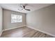 Well-lit bedroom with wood-look floors and window with blinds at 275 Adorno Dr, Henderson, NV 89074