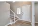 Bright entryway with hardwood floors, staircase, and white door at 275 Adorno Dr, Henderson, NV 89074