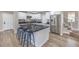 Modern kitchen with white shaker cabinets, dark countertops, and island with seating at 275 Adorno Dr, Henderson, NV 89074