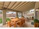 Covered patio with wooden dining set and pool view at 275 Adorno Dr, Henderson, NV 89074