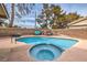 Kidney-shaped pool with spa and grassy backyard at 275 Adorno Dr, Henderson, NV 89074