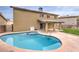 Backyard oasis with a kidney-shaped pool and spa at 275 Adorno Dr, Henderson, NV 89074