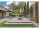 Landscaped backyard featuring a fire pit and hot tub at 3 Glendora Ct, Henderson, NV 89052