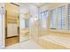 Spa-like bathroom with soaking tub, walk-in shower, and mirrored closet at 3 Glendora Ct, Henderson, NV 89052