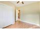 Bedroom with wood-look floors, ceiling fan, and access to bathroom at 3 Glendora Ct, Henderson, NV 89052