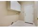 Bright laundry room, featuring overhead cabinets and tile floor at 3 Glendora Ct, Henderson, NV 89052