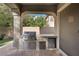 Outdoor kitchen with stainless steel appliances and stone countertops at 3 Glendora Ct, Henderson, NV 89052