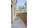 Narrow backyard featuring brick pavers and artificial turf at 3041 Savella Ave, Henderson, NV 89044