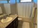 Clean bathroom with tub shower, granite vanity, and updated fixtures at 3041 Savella Ave, Henderson, NV 89044