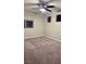 Bare bedroom with multiple windows, carpeted floor, ceiling fan, and neutral walls at 3041 Savella Ave, Henderson, NV 89044