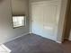 Bedroom with window, carpet flooring and sliding closet doors at 3041 Savella Ave, Henderson, NV 89044